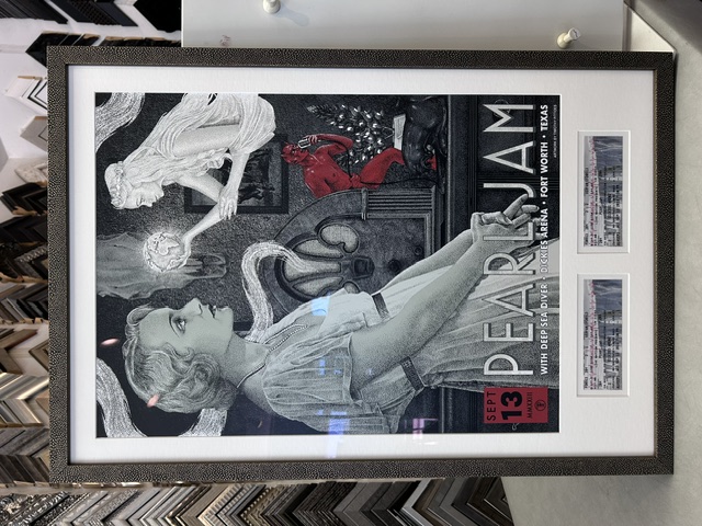 Framed Pearl Jam Fort Worth concert poster displayed with concert tickets