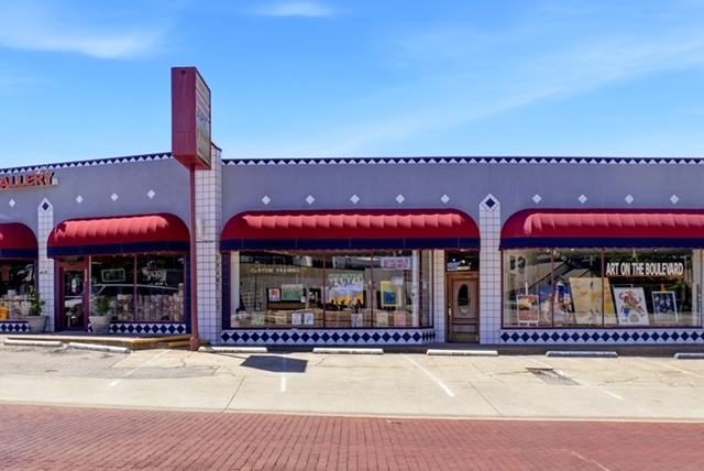 The Frame Up storefront on Camp Bowie Boulevard, with red awnings and Art on the Boulevard / Custom Framing signage